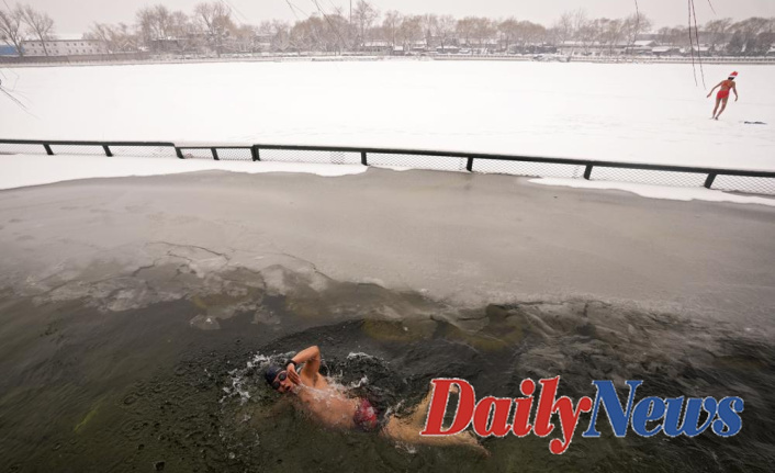 BEIJING SSNAPSHOT: Swimmers dive in an icy lake close to the Olympics