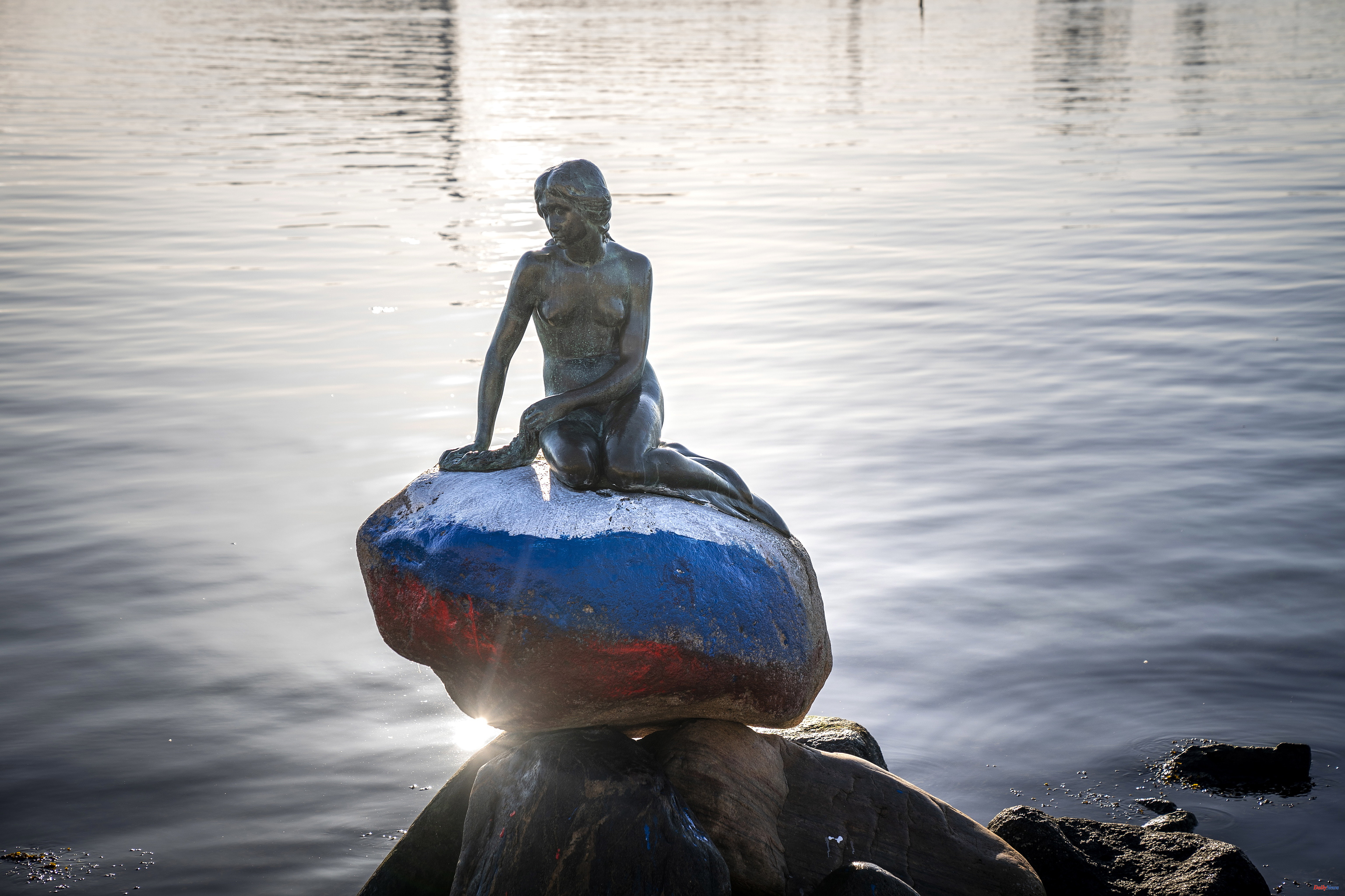 Denmark The Little Mermaid of Copenhagen appears painted in the colors of the Russian flag