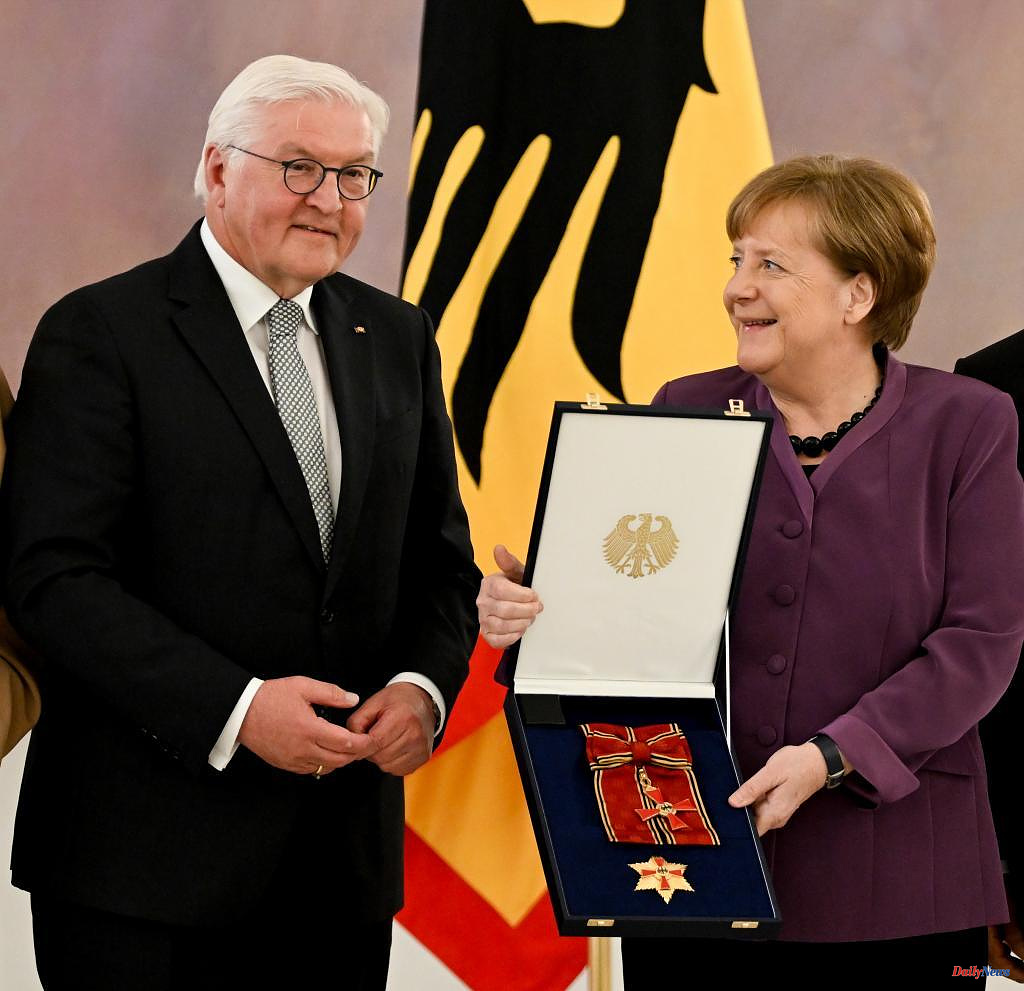 Europe Merkel receives Germany's highest decoration with her legacy imploding