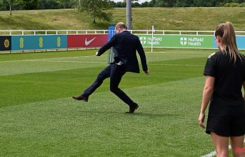 Kick it like William: Prince William plays football - in a suit