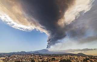 Mount Etna booms once more, sending up a towering...