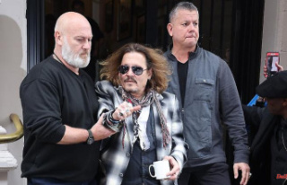 Accompanied by bodyguards: Johnny Depp is "besieged...