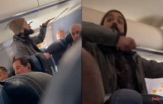 USA A man tries to open an emergency exit in mid-flight...