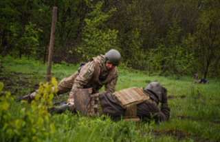 International Ukrainian soldiers dig trenches under...