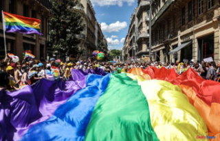 For the Pride March, thousands of people parade in...